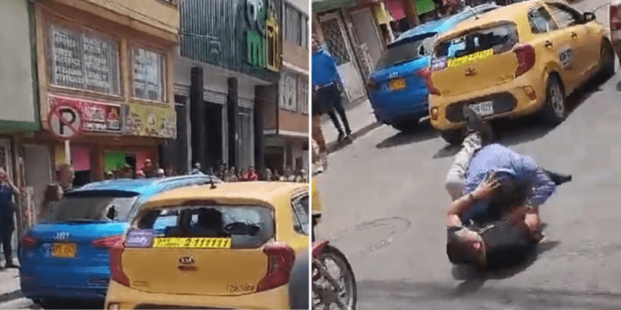 Pareja en camioneta de lujo se enfrenta violentamente con un conductor de Taxi en Bogotá